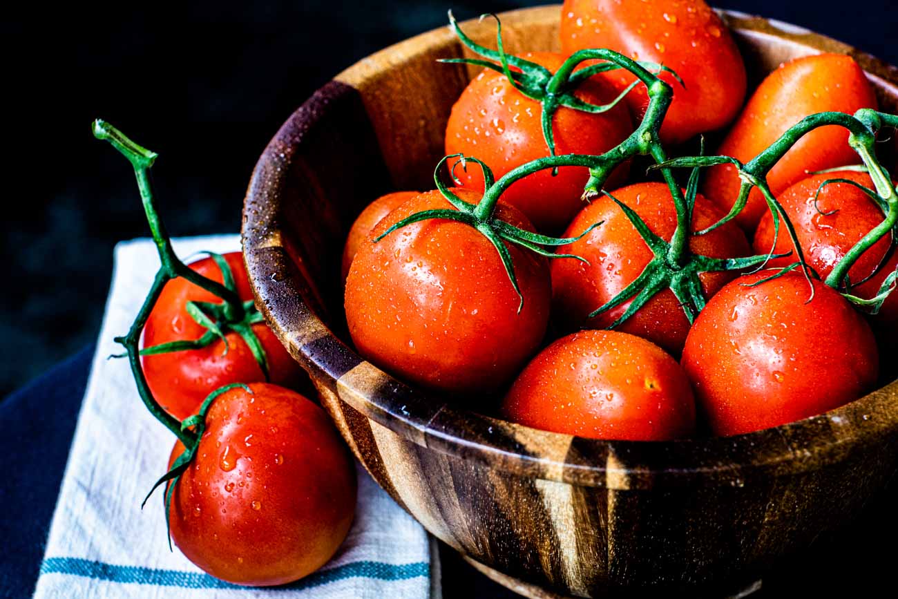 Build Your Own 16 Tomatoes on the vine in a wooden bowl.