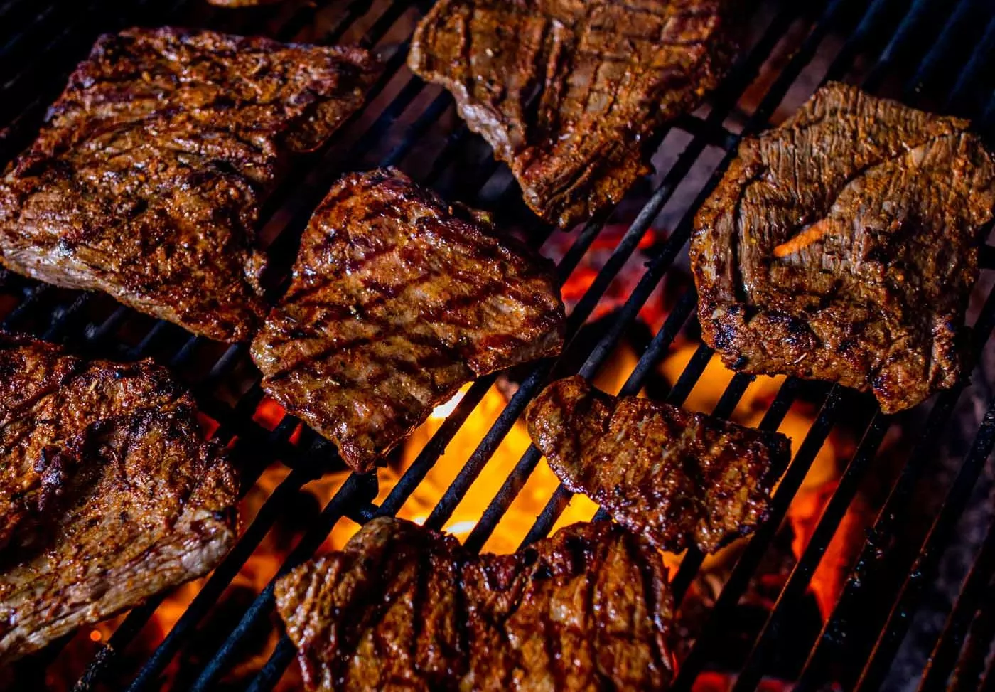 Steaks on a lit grill.